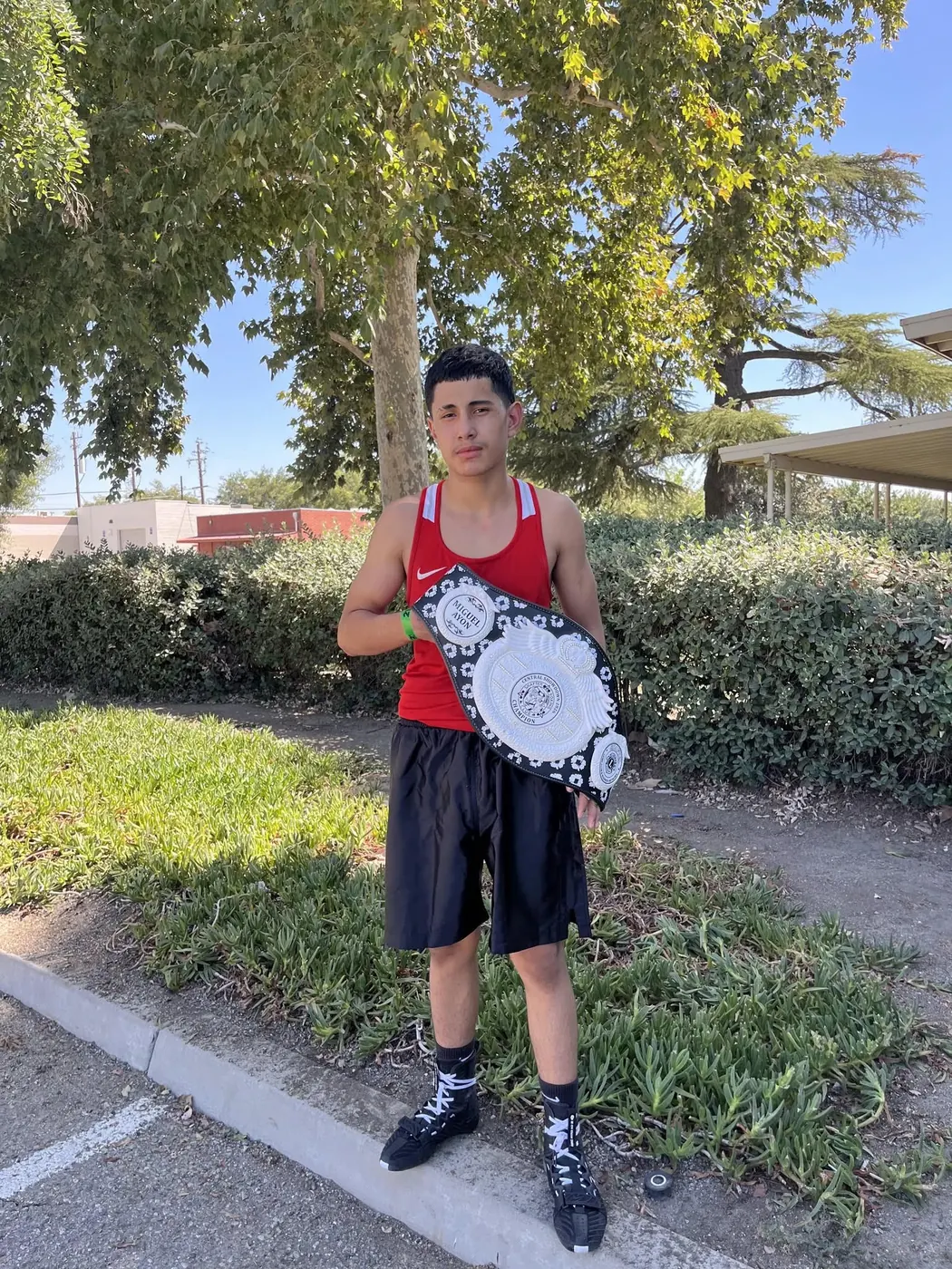 Fresno PAL boxer Eric with his championship belt